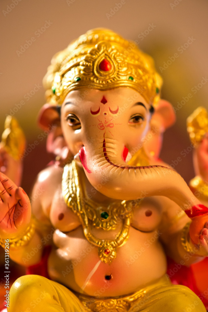 Close up beautifully hand crafted Ganesha Idol. Greeting card cover photo for Hindu Festivals.