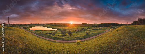 Panorama of majestic colorfull sunset over the river valley
