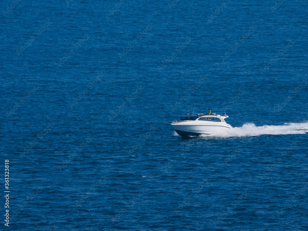A speed boat running and splashing at the ocean A speed boat running and splashing at the ocean