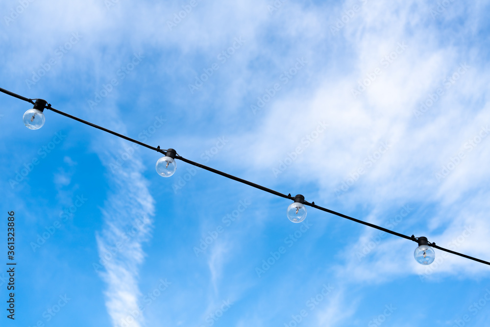 LED round light bulbs against the blue sky in the afternoon on the rope LED round light bulbs against the blue sky in the afternoon on the rope