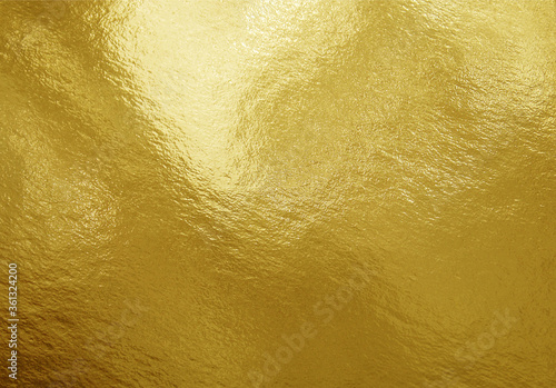Gold foil texture background with highlights and uneven surface