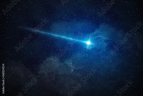 falling star shining in starry night sky