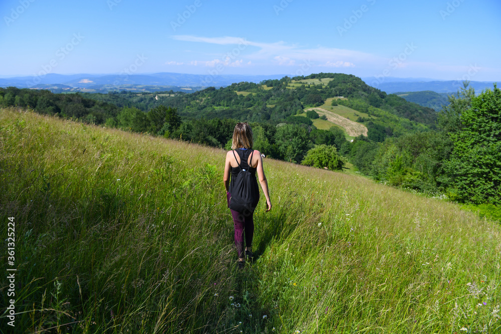 Fototapeta premium Girl outdoors enjoying nature on the field