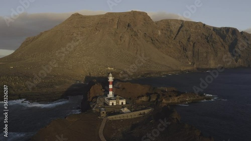 Sunset fly above Tenerife lighthouse Punta Teno west point mountains ocean waves with drone