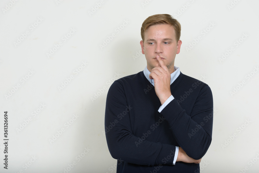 Portrait of man with blond hair thinking and looking down Portrait of man with blond hair thinking and looking down