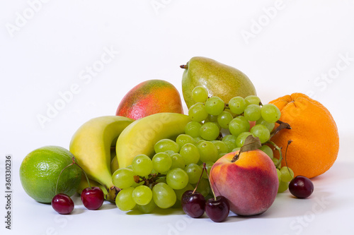 Assorted fresh ripe fruits on a light background. Healthy eating concept.