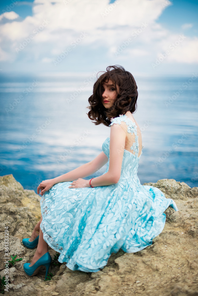 Beautiful young girl in a dress with butterflies on the beach. Portrait Beautiful young girl in a dress with butterflies on the beach. Portrait