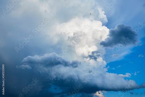 Big dark cloud against the blue sky, it's going to rain soon