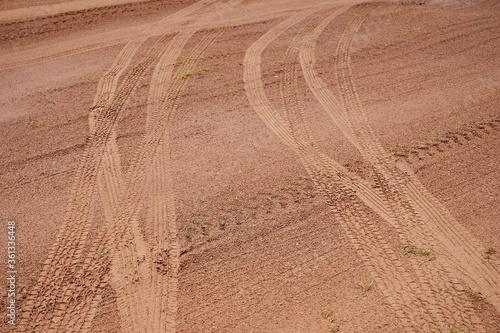 Tracks from car wheels on the wet sand after the rain, passed two cars