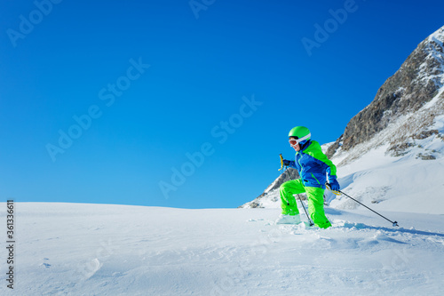 Boy in hiking school stepping on virgin snow winter activity concept