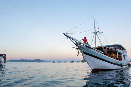 June 14, 2018 - Labuan Bajo : A person standing on the fore of a boat overlooking the sea around Komodo National Park