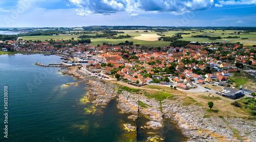 Panorama der dänischen Stadt Svaneke auf der Insel Bornholm an einem Sommertag mit Blick auf die Granitfelsen und Häuser mit roten Dächern. photo