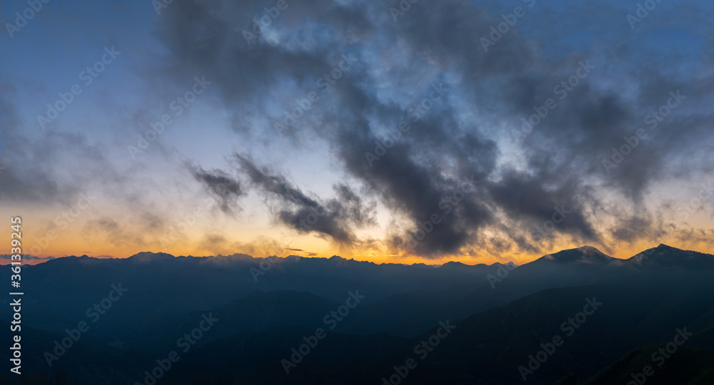 Fototapeta premium Silhouette Maritime Alps mountain range against sky at sunset, South France