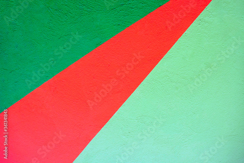 Green and red bright stripes on light colored wall