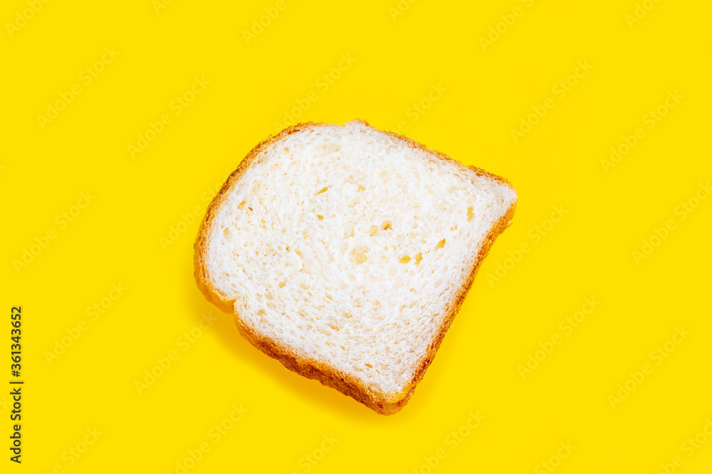 Close up photo of fresh baked toast bread on yellow background. Top view. Bread for breakfast.