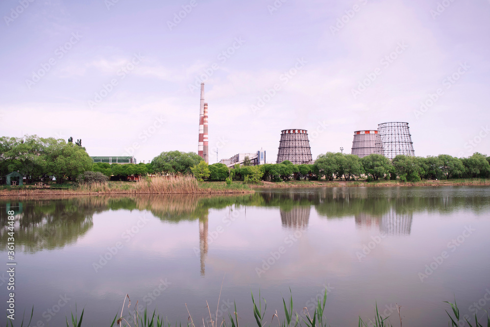 Industrial buildings beside green summer lake