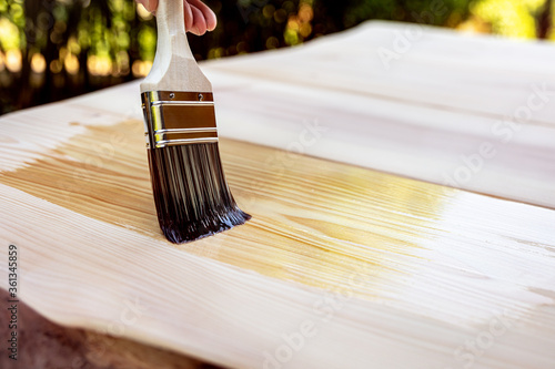 glazing of a wooden table with a hair brush and oil photo