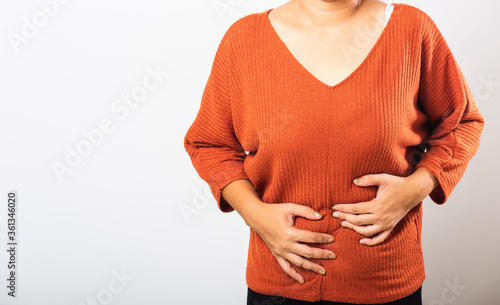 Wallpaper Mural Asian woman she sick have stomach ache holds hands on abdomen, part of body, female having painful stomachache she abdomen bloating or chronic gastritis, studio shot isolated on white background Torontodigital.ca