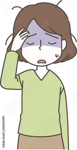 疲れて頭を抱える女性