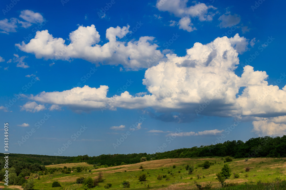 Spring landscape with green trees, meadows, fields and blue sky Spring landscape with green trees, meadows, fields and blue sky