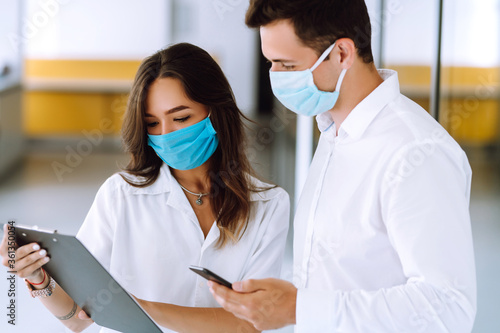 Business people with face mask working in the office. The concept of preventing the spread of the epidemic and treating coronavirus  pandemic in quarantine city. Covid-19.