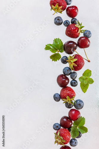 Fresh juicy berries and fruits on a white background, isolated, close-up, top view