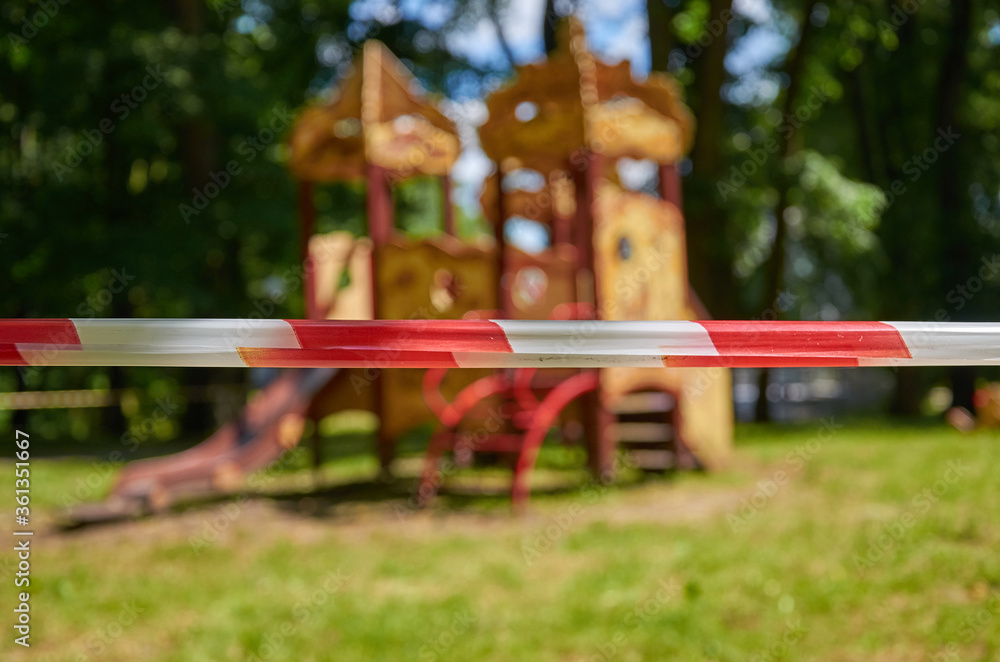 Red and white barrier tape near the Playground