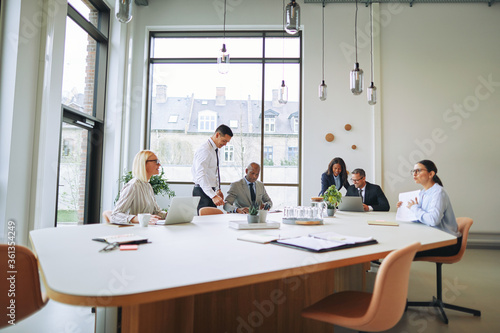 Diverse businesspeople working together around a boardroom table