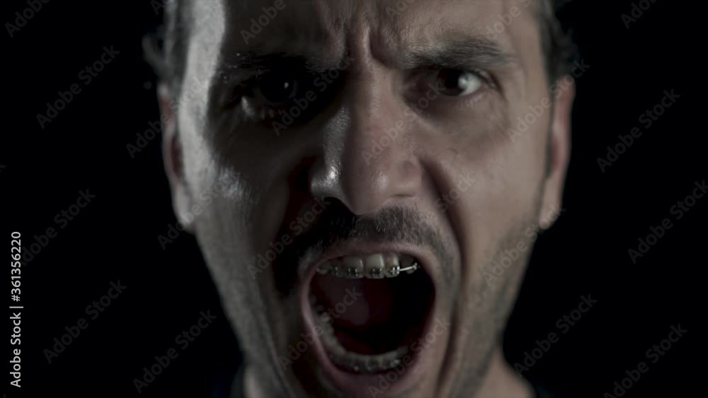 Young handsome guy with brace is screaming. Angry, depressed man is in problem. Young handsome guy with brace is screaming. Angry, depressed man is in problem.