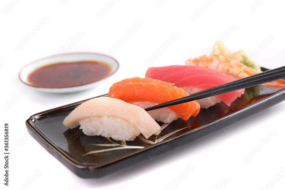 Sushi set , Japanese food sushi salmon tuna shrimp and sea bass with chopsticks isolated in white background Sushi set , Japanese food sushi salmon tuna shrimp and sea bass with chopsticks isolated in white background