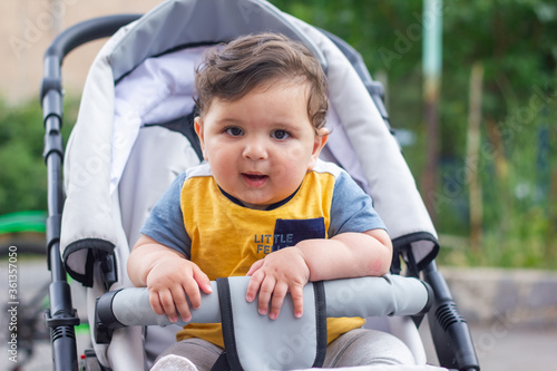 baby boy in stroller in the garden