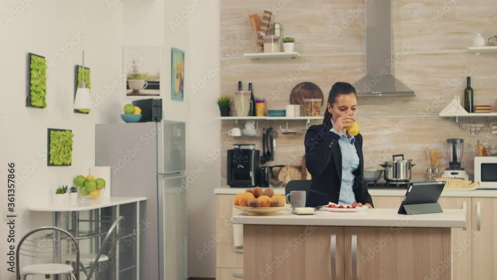 Woman hurrying up to finish breakfast while she's late at work. Young freelancer working around the clock to meet her goals, stressful way of life, hurry, late for work, always on the run Woman hurrying up to finish breakfast while she's late at work. Young freelancer working around the clock to meet her goals, stressful way of life, hurry, late for work, always on the run
