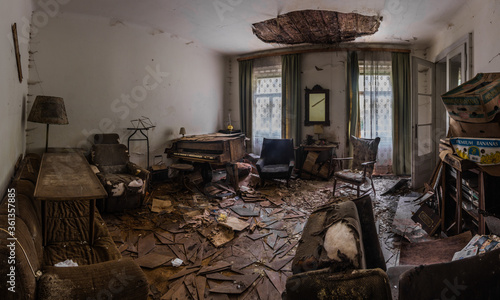 abandoned room with a piano chair and a lamp panorama