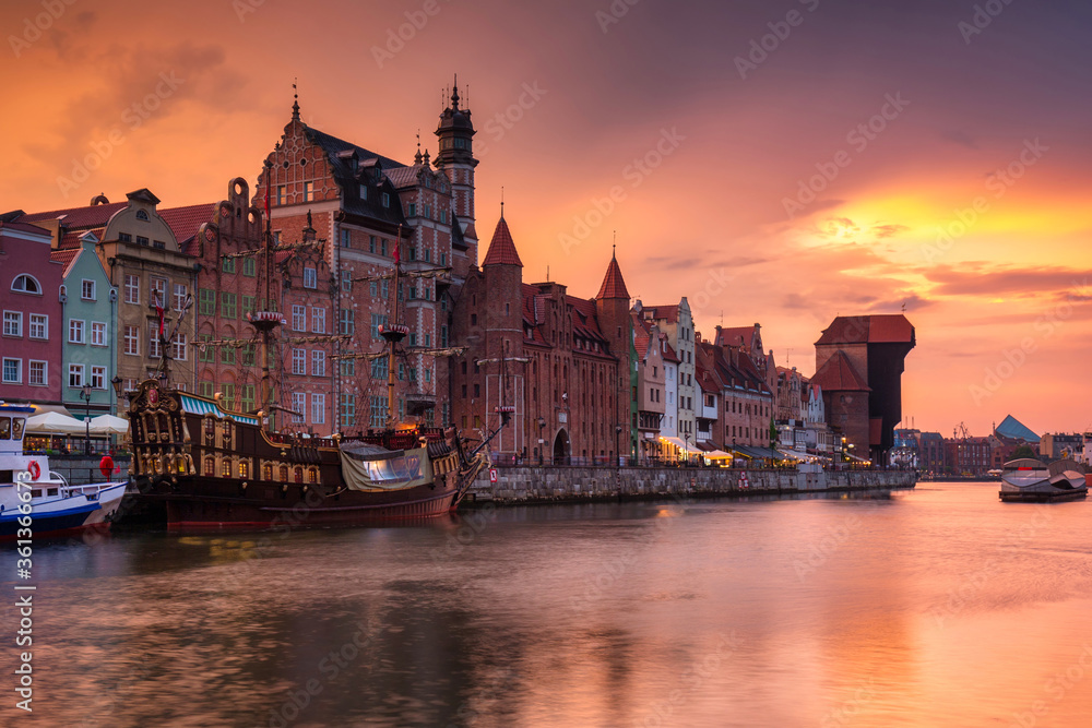 Old town in Gdansk with historical port crane over Motlawa river at sunset, Poland.