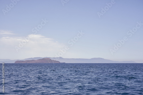 Rocky sea coast of Crete, Greece on a sunny day with clear sky.