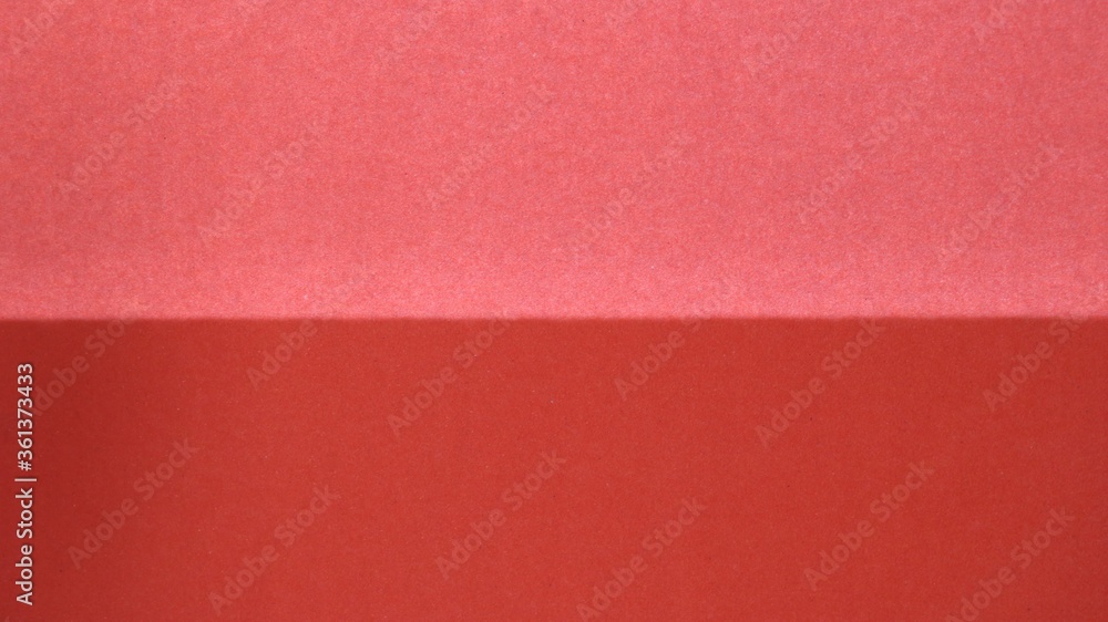 Fototapeta premium red paper or fabric background light above and dark below as an empty surface for design use