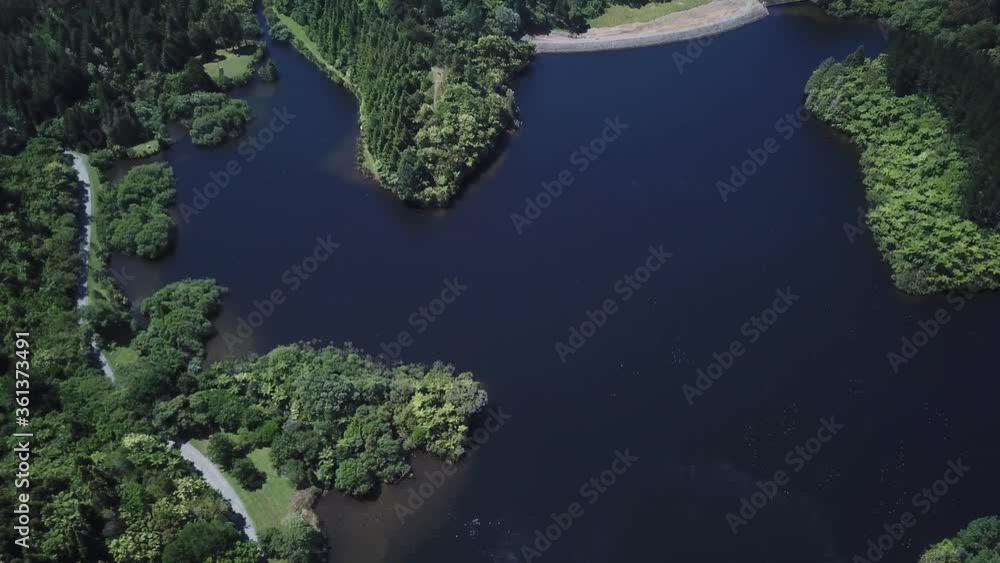 aerial shot, bird view of a lake with walking track and surrounded by bush in New Plymouth, New Zealand. aerial shot, bird view of a lake with walking track and surrounded by bush in New Plymouth, New Zealand.