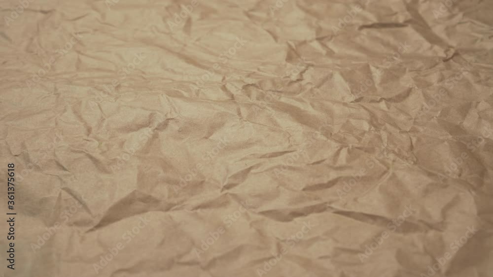 Crumpled shabby wrapping brown paper close-up. Abstract textured background Crumpled shabby wrapping brown paper close-up. Abstract textured background