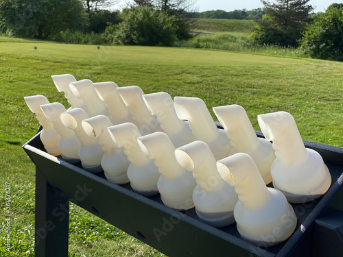 Картината върху платно Containers of sand are ready for golfers to place on their carts, as they are encouraged to fill in their divots