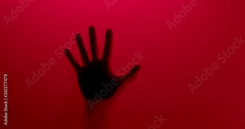  One hand appears and slowly goes back. Abstract. Red 
