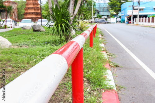 White-red iron fence on the sidewalk