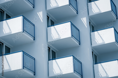 Bild auf Leinwand Building with evenly protruding white-blue balconies, Side view