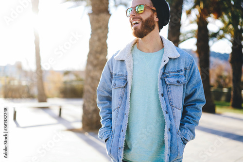 Photography Emotional cheerful male hipster dressed in trendy outfit with copy space for ban