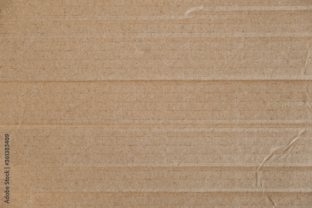 Fototapeta premium Crumpled corrugated cardboard surface texture background. Seamless crumpled brown paper textured backdrop. Top view. Copy, empty space for text