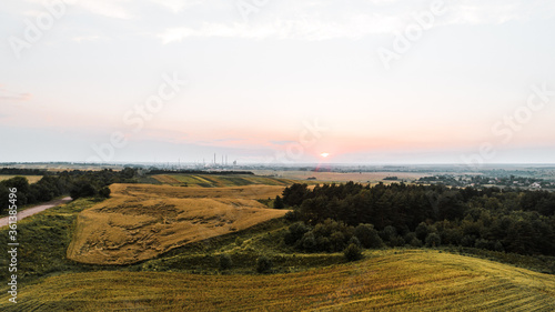 Fototapeta Naklejka Na Ścianę i Meble -  Ariel shot of sunset and beautiful fields