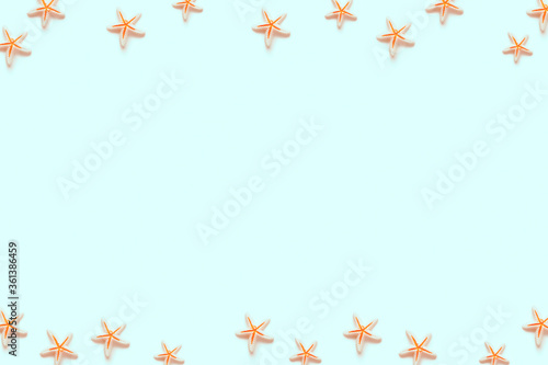 Preparing for vacation and travel. Creative travel background. Layout of starfish miniatures. Flat lay. Top view. Copy space.