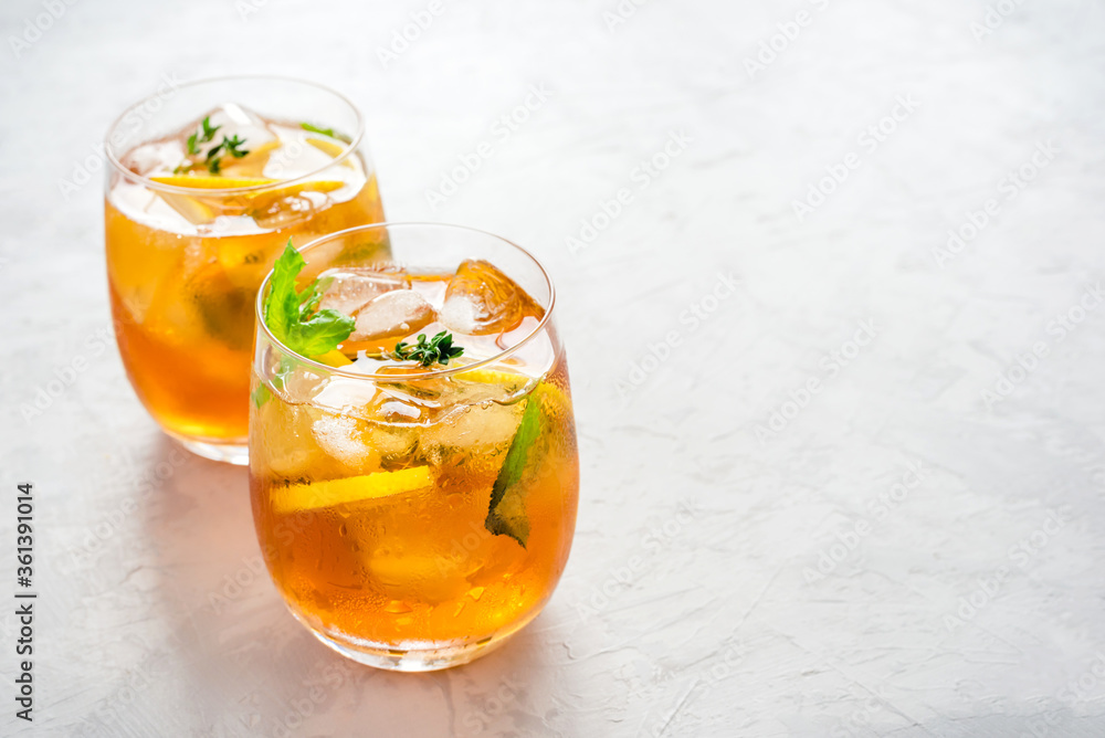 Iced tea with ice, mint and lemon. Refreshment cold summer drink. Iced tea with ice, mint and lemon. Refreshment cold summer drink.