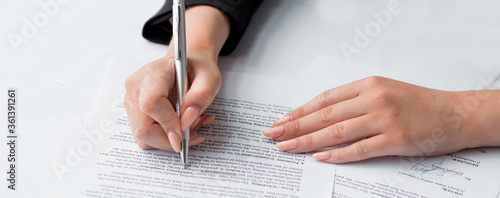 Canvas Print Businesswoman's hand with pen completing personal information on a form