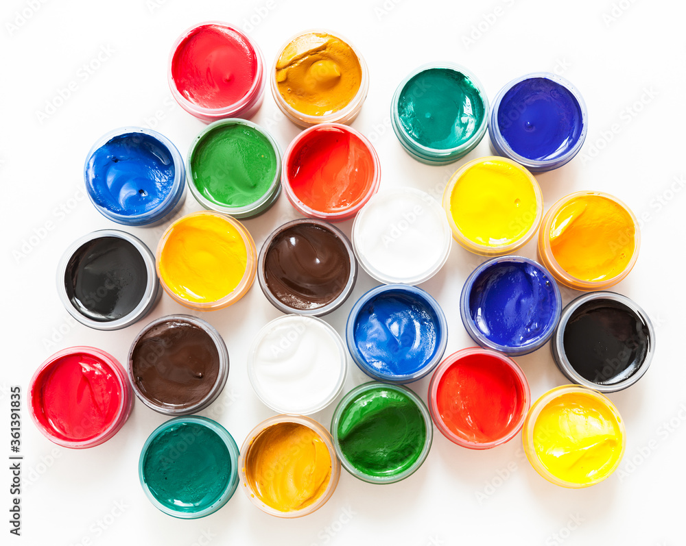 Set of plastic cans with colored paints, white background, top view Set of plastic cans with colored paints, white background, top view