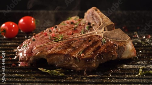T-Bone Steak with rosemary and cherry tomatoes on the grill